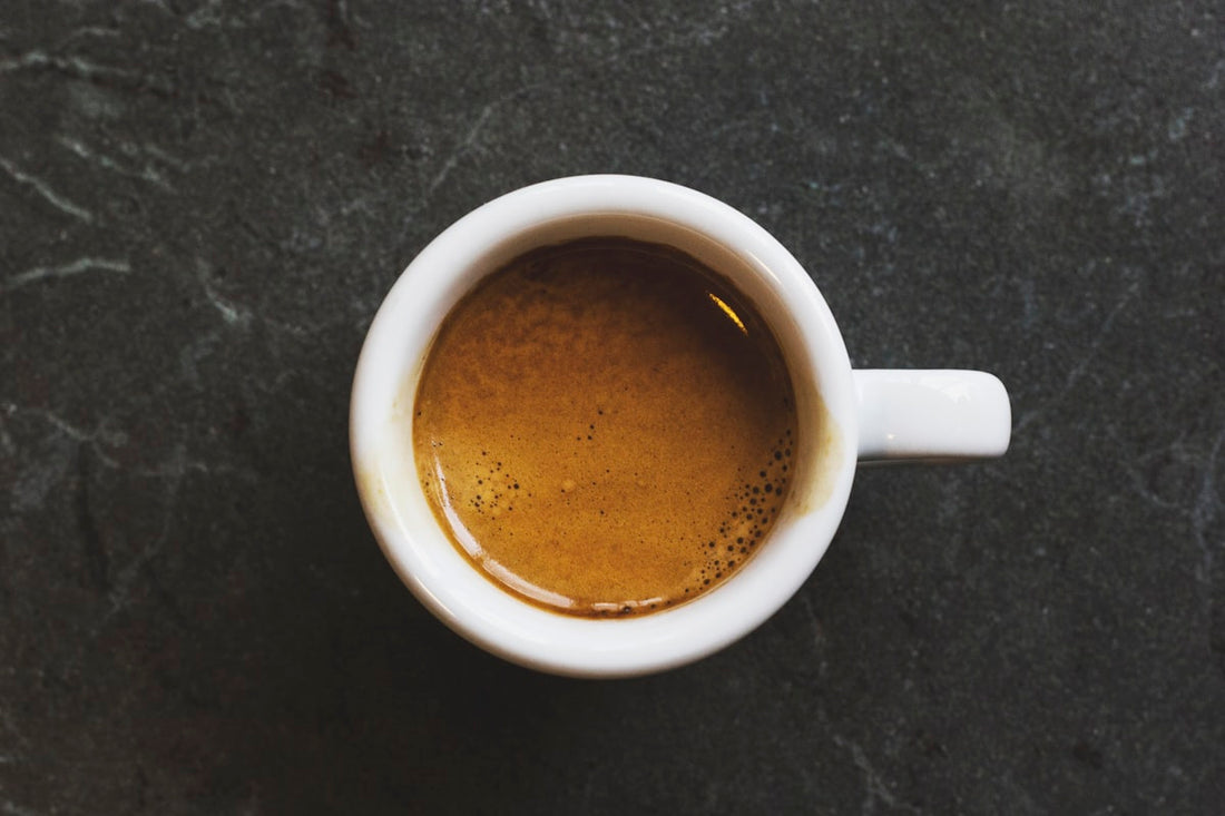 Cuban espresso cafecito with crema in a small white cup